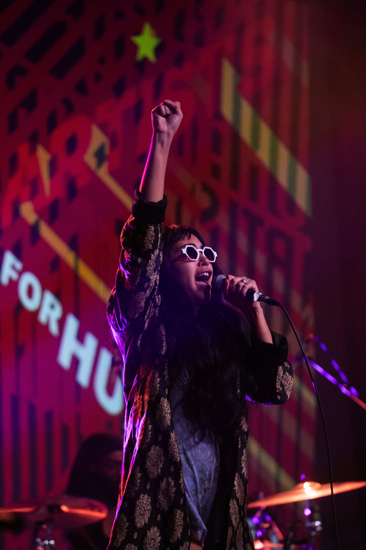 Performer raising a fist at Artists for Humanity