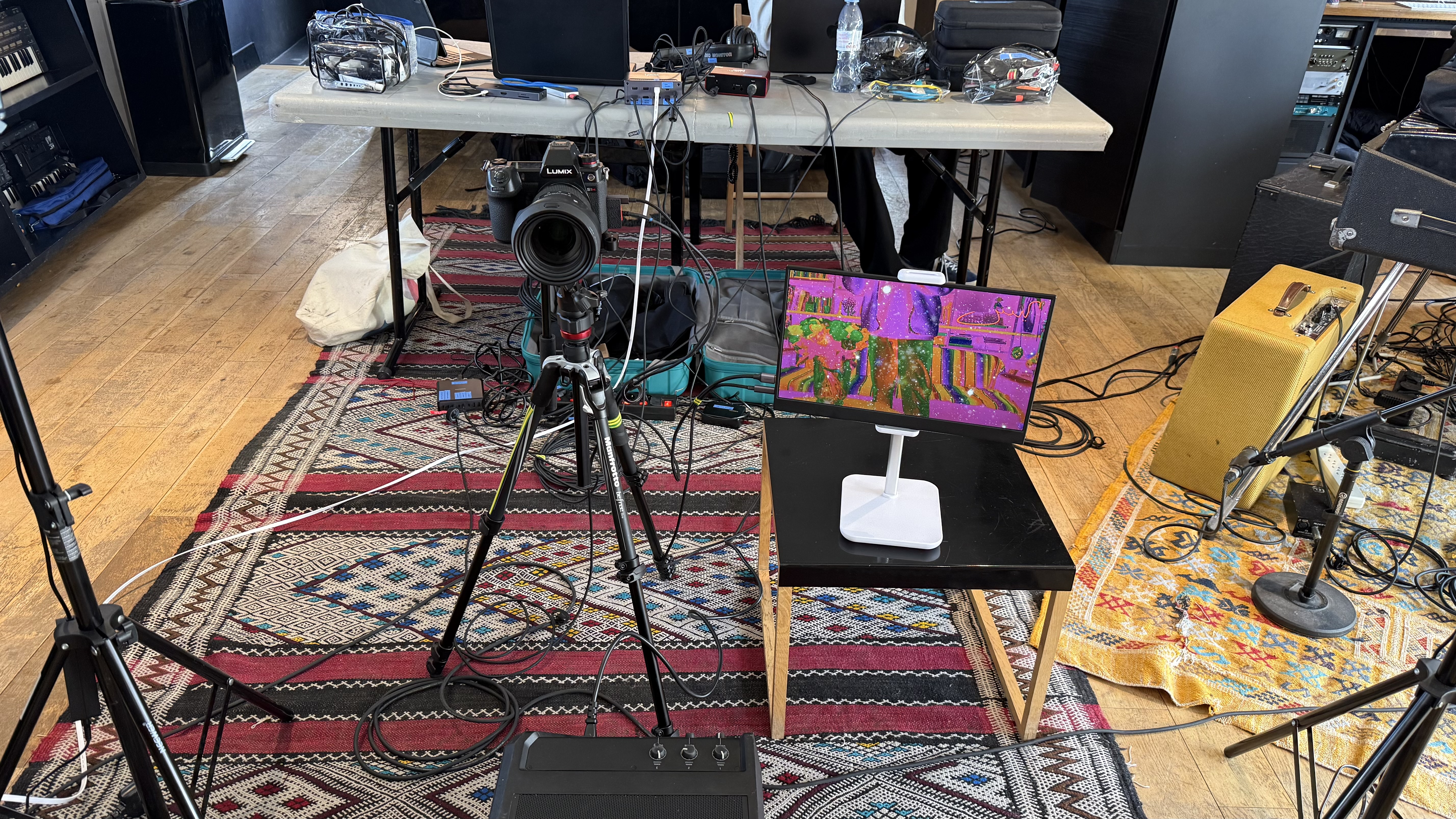 Camera, monitor and cables arranged on the studio floor for the livestream