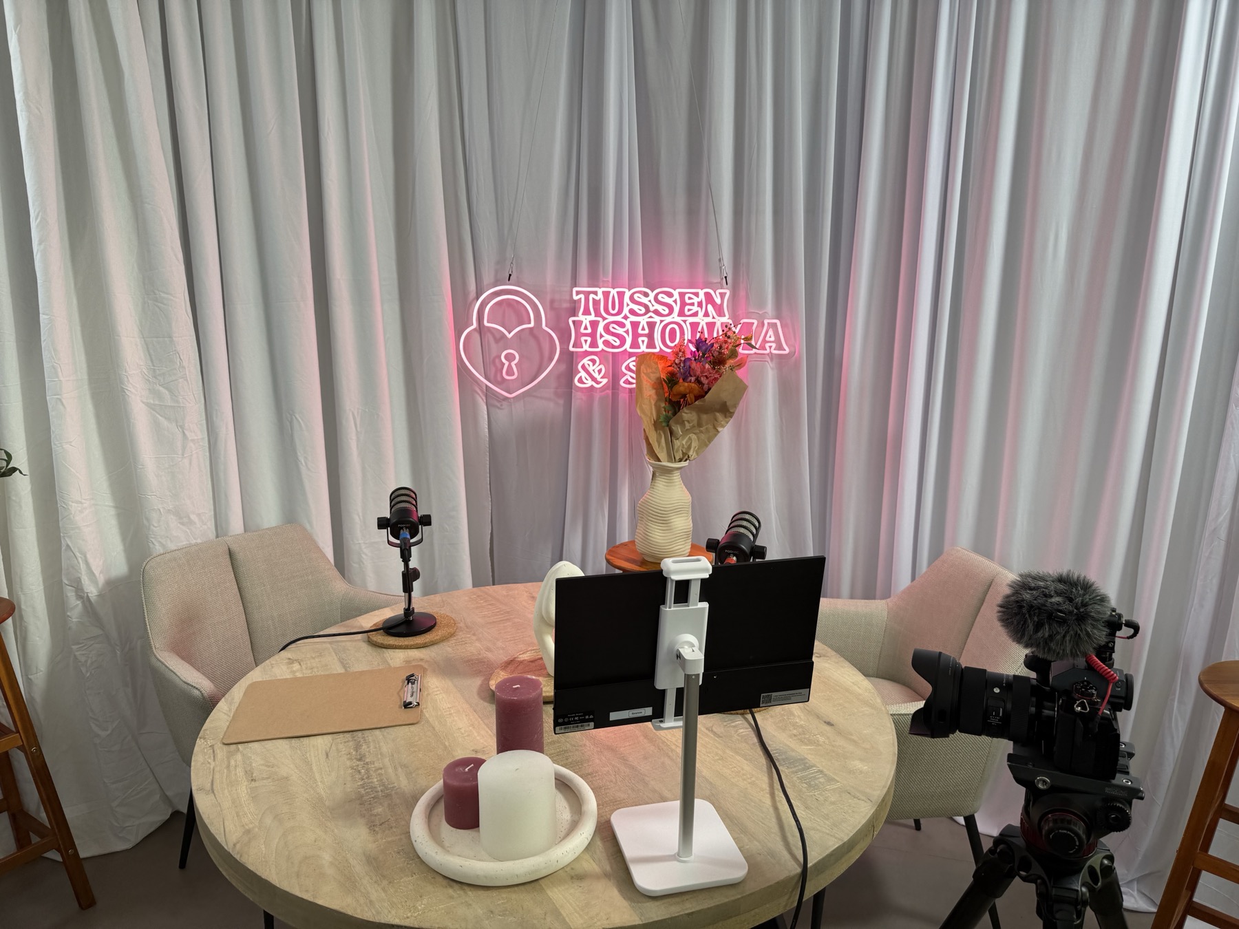 New podcast set with neon sign